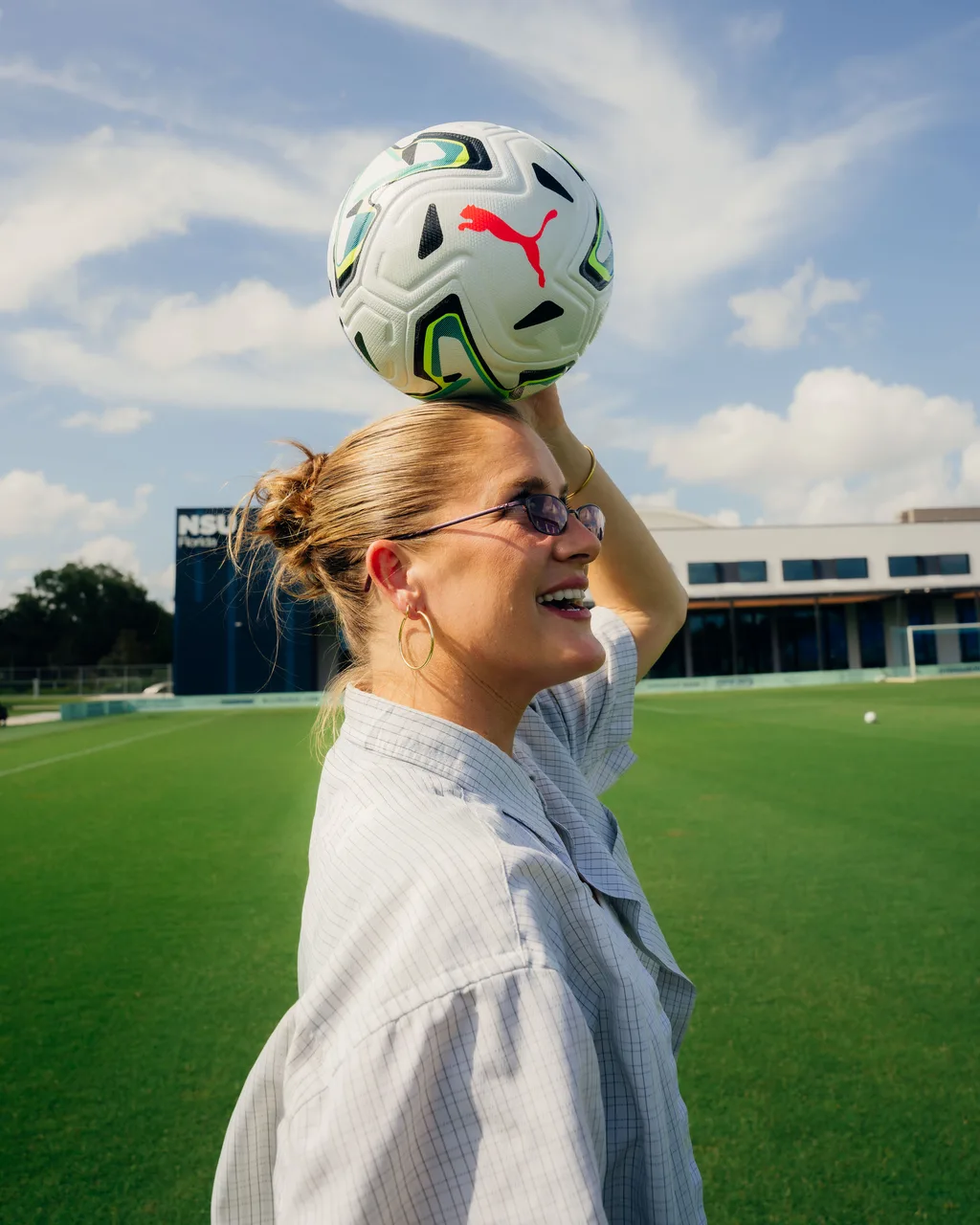 Woman balancing a PUMA match ball on her head