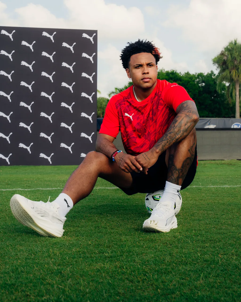 Weston McKennie sitting on a ball in front of a PUMA backdrop