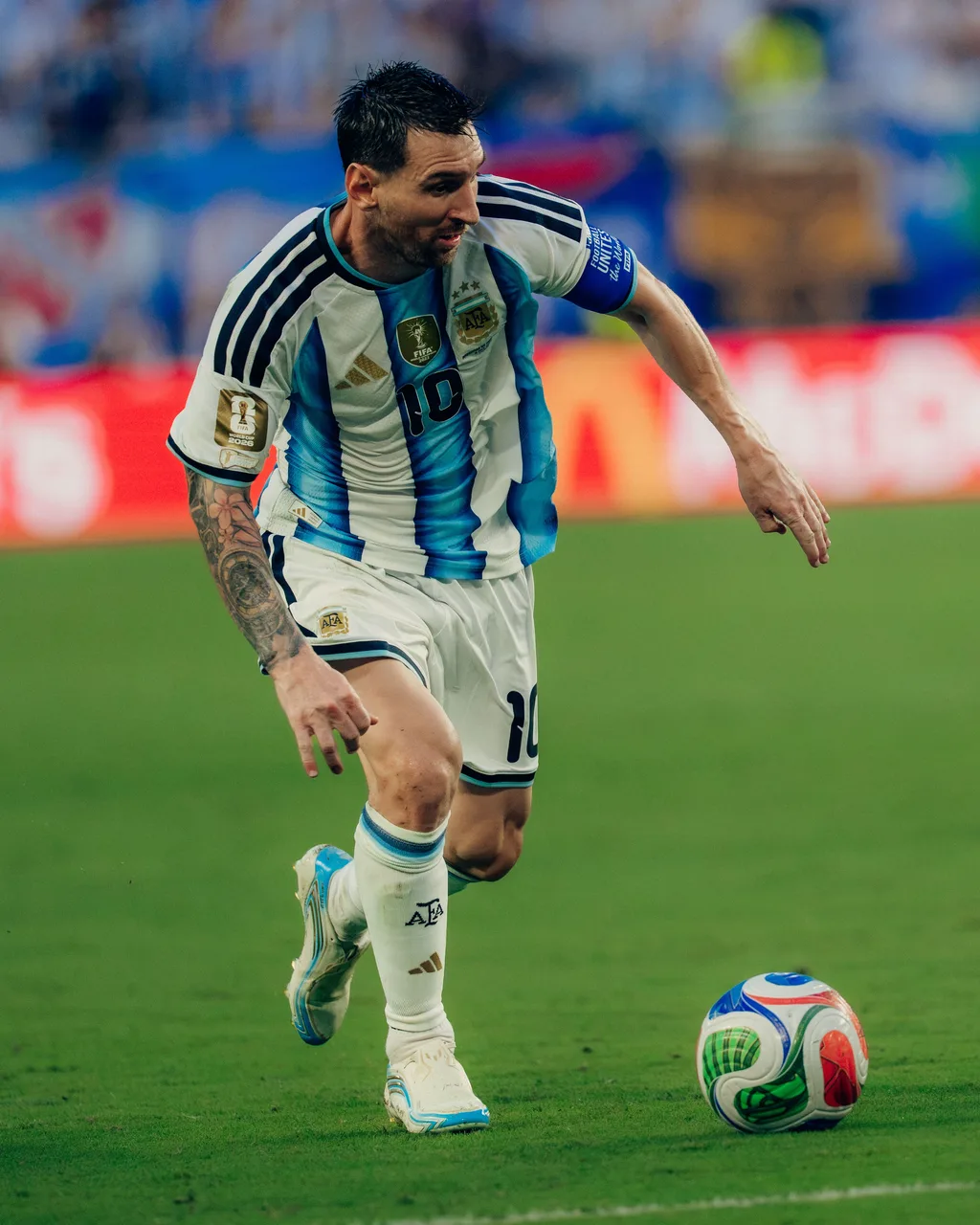 Lionel Messi running onto the ball