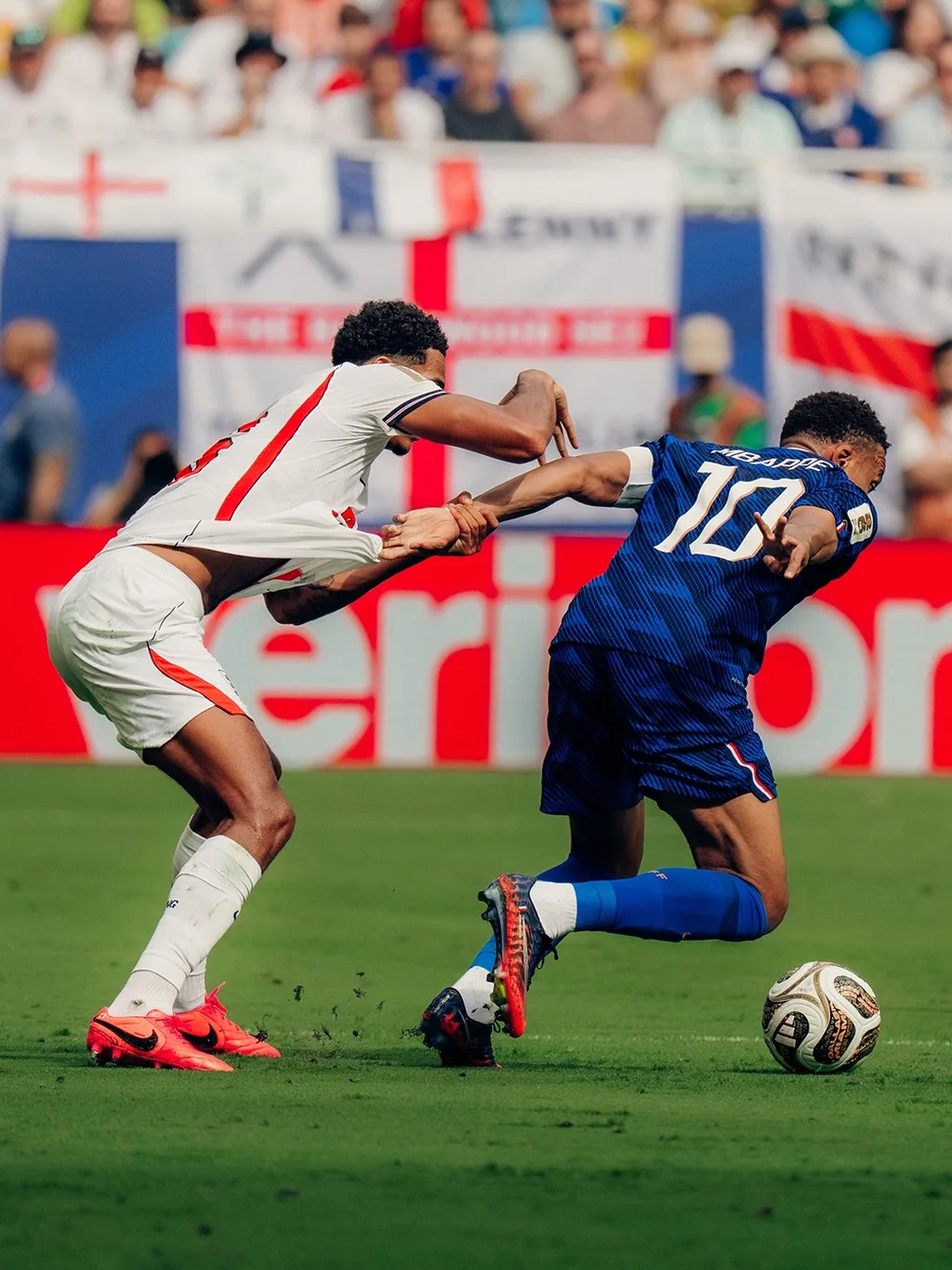 An England and a France player battling for the ball