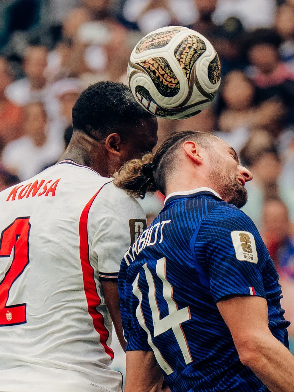 Ezri Konsa of England and Adrien Rabiot of France rising for a header