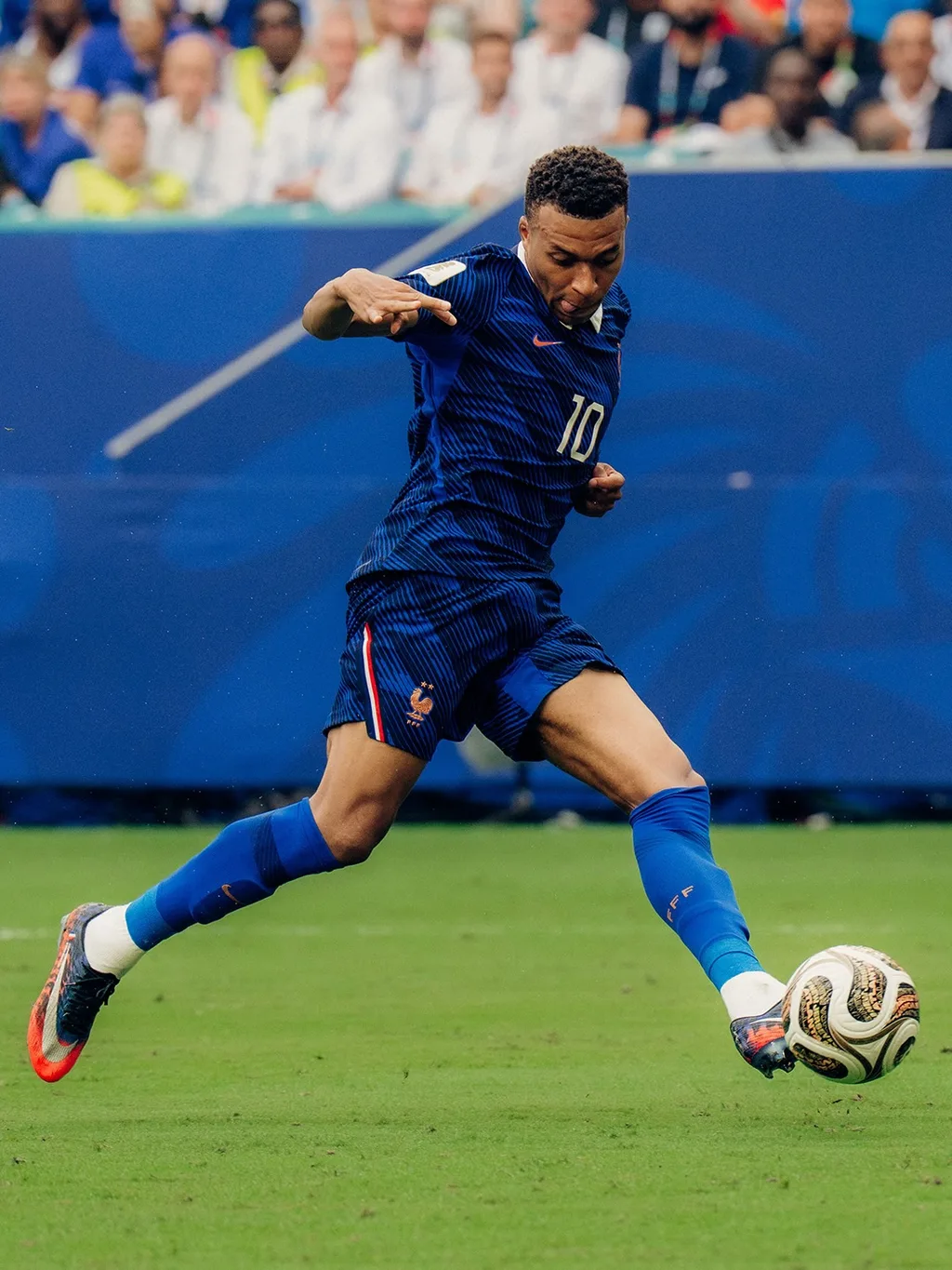 Kylian Mbappé of France striking the ball